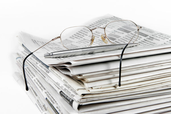 Stack of newspapers on white background (Zoom on click)