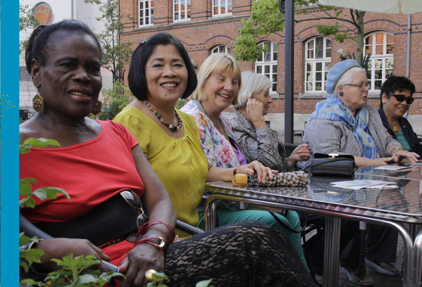 Frauen aus verschiedenen Kulturen sitzen zusammen am Tisch