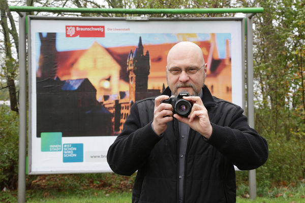 Fotowettbewerb „#braunschweigistschön“ der Citymarketingkampagne „Ist schön. Wird schön“: Helge Fehs vor seinem Gewinnermotiv „Am Dom“ auf einer 3,5 m mal 2,5 m großen Plakatwand. (Wird bei Klick vergrößert)
