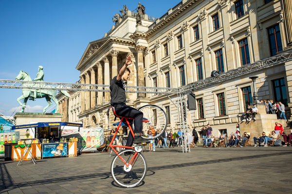 Akrobatik auf dem Rad: Mit einem kühlen Getränk genossen die Gäste auf dem Schlossplatz Sonne und Kunstradshow im Liegestuhl. (Wird bei Klick vergrößert)